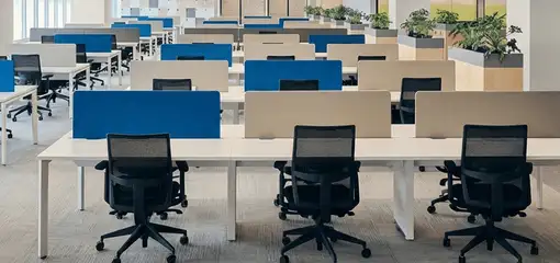 Modern open-plan office space featuring clean workstations, ergonomic chairs, and sanitized carpets provided by professional office cleaning services in Chandler, AZ.