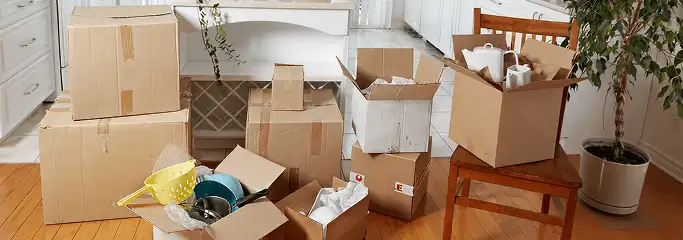 Packed moving boxes and household items in a kitchen before move-out or move-in cleaning, Chandler, AZ.